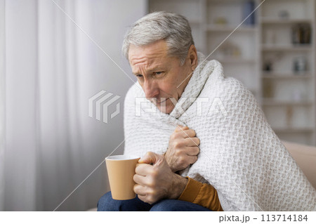 Senior with a cup holding a square board 113714184
