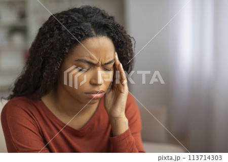 Black Woman Experiencing Headache at Home 113714303