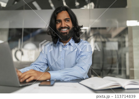 Smiling professional at computer Smiling professional at computer 113714839