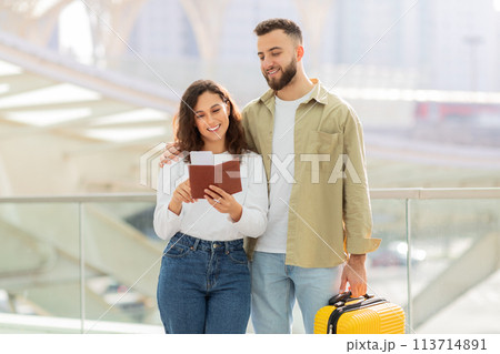 Young Couple With Suitcase and Passport Standing at Airport Daytime 113714891