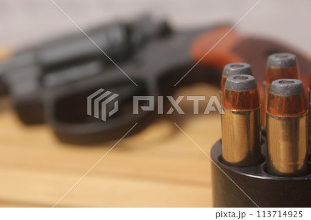 Vintage Revolver Gun With Ammunition and Speed Loader Vintage Revolver Gun With Ammunition and Speed Loader 113714925