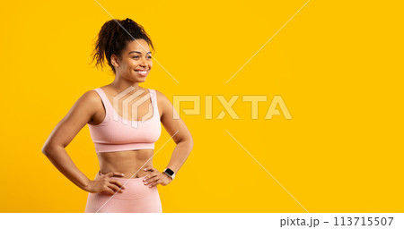 Confident black lady in fitness attire isolated 113715507