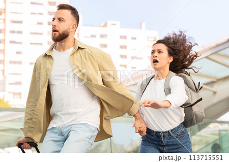Man looking shocked holding woman's hand Man looking shocked holding woman's hand 113715551