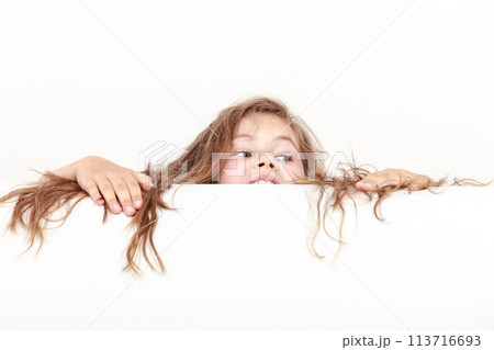 Little girl kid with long hair holds empty banner. 113716693