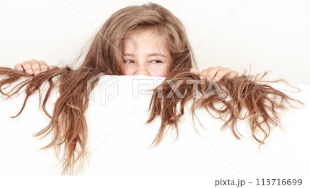 Little girl kid with long hair holds empty banner. 113716699