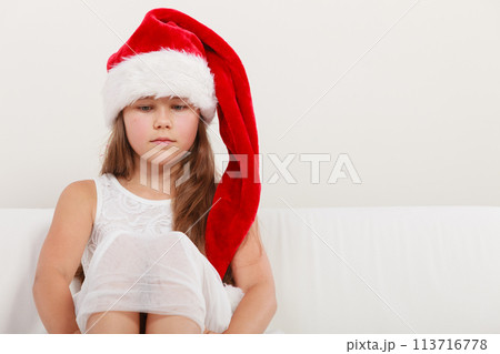 Lonely little girl kid in santa hat. Christmas. Lonely little girl kid in santa hat. Christmas. 113716778