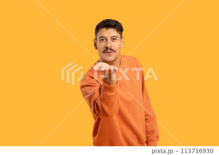Guy with moustache blowing a kiss on orange 113716930
