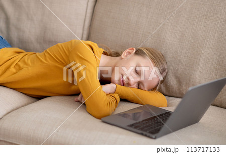 Tired Teen Girl Felt Asleep On Couch After Using Laptop At Home Tired Teen Girl Felt Asleep On Couch After Using Laptop At Home 113717133