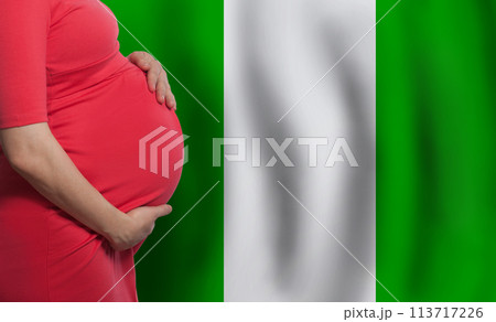 Pregnant woman belly on Nigerian flag background 113717226