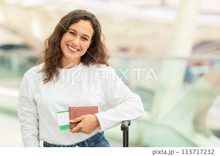 Happy traveler holding passport and tickets 113717232