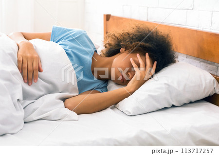 Asleep woman trying to wake up in the morning 113717257