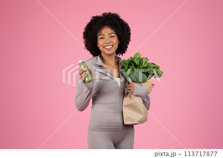 Cheerful woman with fresh groceries on pink background Cheerful woman with fresh groceries on pink background 113717877