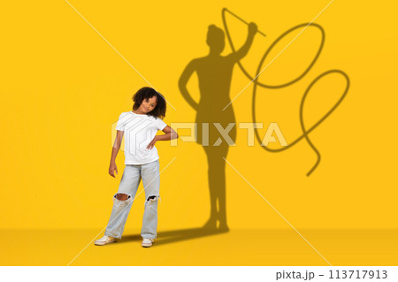 A confident young girl stands with her hand on her hip in casual clothing A confident young girl stands with her hand on her hip in casual clothing 113717913