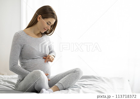 Pregnant woman enjoying a moment of calm at home Pregnant woman enjoying a moment of calm at home 113718372