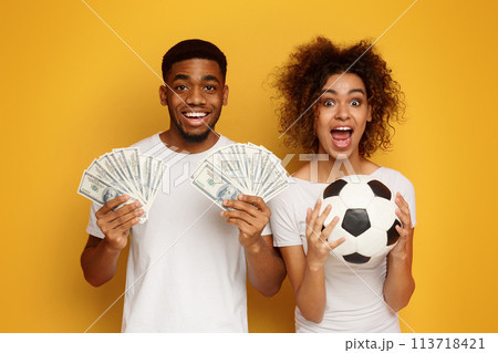 Excited african-american couple enjoying sport bet win 113718421