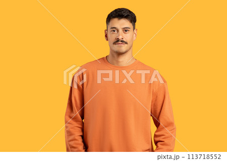 Man with moustache standing against yellow background 113718552