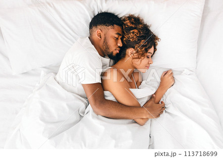 Loving couple sleeping in bed and hugging 113718699