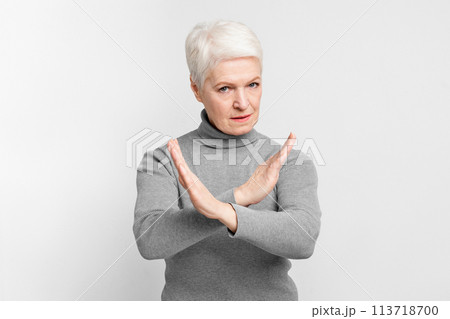Senior making an X sign with her arms 113718700