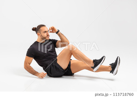 Man doing sit-ups exercise on studio background Man doing sit-ups exercise on studio background 113718760