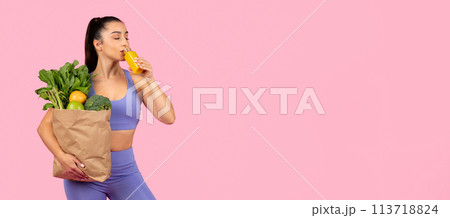Woman drinking orange juice with groceries 113718824