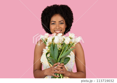 Smiling African American woman holding white flowers 113719032