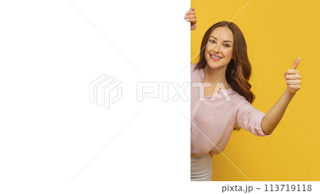 Woman holding blank sign with thumbs up Woman holding blank sign with thumbs up 113719118