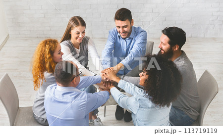 Happy People Sitting In Circle And Stacking Hands, Celebrating Successful Rehabilitation Happy People Sitting In Circle And Stacking Hands, Celebrating Successful Rehabilitation 113719119