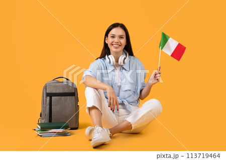 Smiling lady with Italian flag on yellow background 113719464