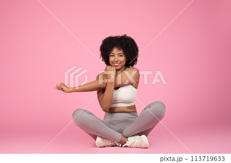 Smiling lady sitting with a yoga pose 113719633