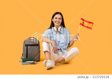 Happy woman with Spanish flag on yellow background Happy woman with Spanish flag on yellow background 113720128