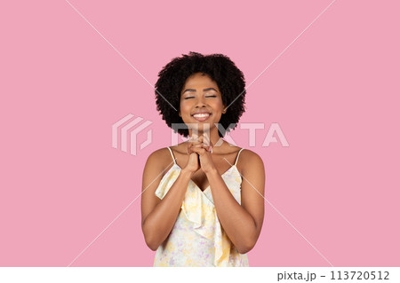 Happy woman with clasped hands on pink Happy woman with clasped hands on pink 113720512