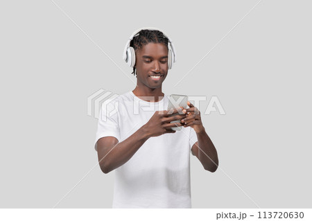 Man enjoying music on smartphone and headphones 113720630