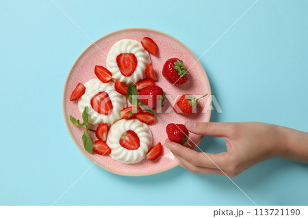 Dessert panna cotta, on the table, on a blue background. 113721190