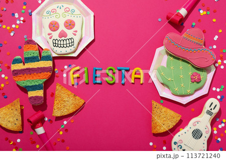 The inscription Fiesta with decorations on a pink background 113721240