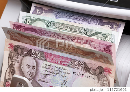 Old Afghan Afghani in a counting machine Old Afghan Afghani in a counting machine 113721691