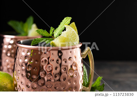 Moscow mule cocktail served with ice and lime slice on wooden table Moscow mule cocktail served with ice and lime slice on wooden table 113723830