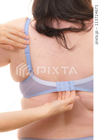 Bra fitter help plus size woman find perfect fit. Back view. Bra fitter help plus size woman find perfect fit. Back view. 113724671