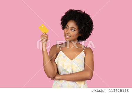 African American woman thinking and holding credit card African American woman thinking and holding credit card 113726138