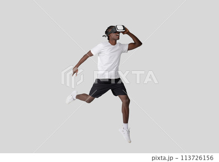 Young man in VR headset with dynamic pose Young man in VR headset with dynamic pose 113726156