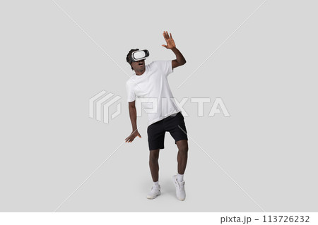 African American man using VR headset on white background African American man using VR headset on white background 113726232
