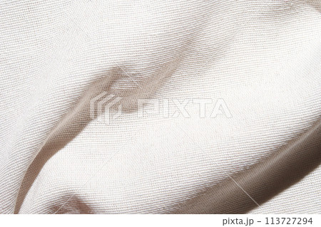 A soft, pure white fabric background with a delicate grid pattern. The texture A soft, pure white fabric background with a delicate grid pattern. The texture 113727294