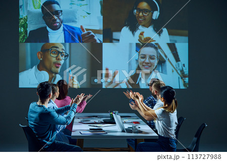 Workers having productive virtual meeting, discussing project plans, exchanging feedback with remote colleagues, applauding for food work 113727988