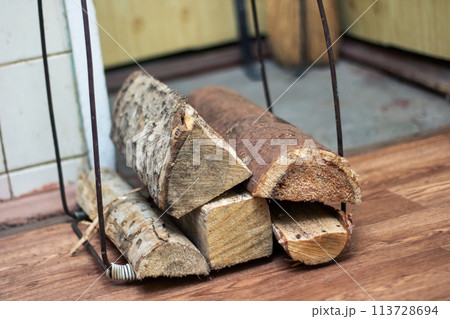 A stack of Brown logs on Hardwood floor, Wood stain on Planks A stack of Brown logs on Hardwood floor, Wood stain on Planks 113728694