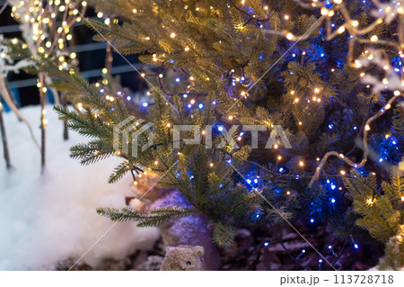 New Year's decorations on green spruce branches New Year's decorations on green spruce branches 113728718