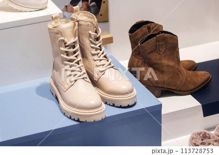 Boots on blue box beside brown boots closeup 113728753