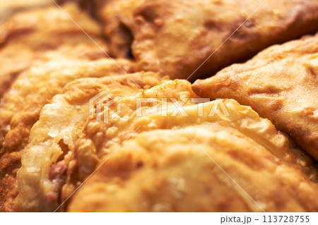 Close up of fried food with pieces missing, tempting dish 113728755