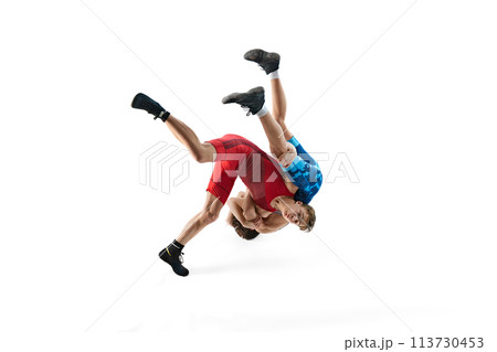 Young male wrestlers demonstrate strength as they engage in competitive bout isolated on white background 113730453