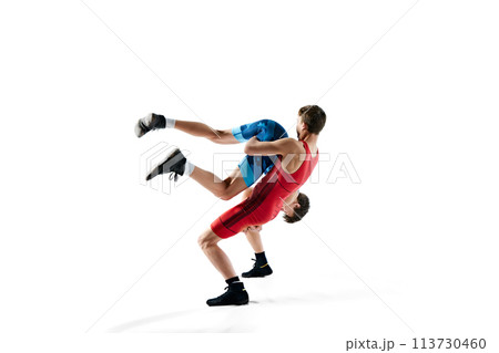 Young men, wrestlers showing athleticism and determination as they grapple isolated on white background 113730460