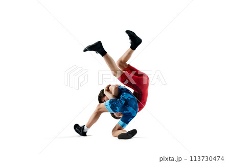 Male wrestlers display power and technique during competition wrestling round isolated on white background 113730474
