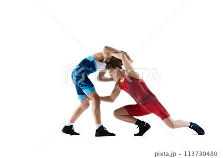 Young boys, wrestlers in dynamic motion, wrestling, training, showing strength and skills in competitive match isolated on white background Young boys, wrestlers in dynamic motion, wrestling, training, showing strength and skills in competitive match isolated on white background 113730480